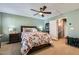 Comfortable bedroom featuring a ceiling fan, carpet, and a view leading to the bathroom at 4650 Ranch House Rd # 42, North Las Vegas, NV 89031