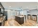 Spacious kitchen featuring an island with barstool seating, stainless appliances, and wood flooring at 4650 Ranch House Rd # 42, North Las Vegas, NV 89031