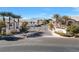 Gated community entrance with palm trees and signage at 4921 Black Bear Rd # 104, Las Vegas, NV 89149