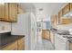 Galley kitchen with wood cabinets and view to Gathering room at 503 Fragrant Orchard St, Henderson, NV 89015