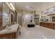 Spa-like bathroom featuring a large vanity, soaking tub, and glass shower at 52 Innisbrook Ave, Las Vegas, NV 89113