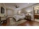 Main bedroom with plush bed, hardwood floors, and ensuite bathroom at 52 Innisbrook Ave, Las Vegas, NV 89113