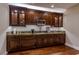 Basement kitchenette with dark wood cabinets and granite counters at 52 Innisbrook Ave, Las Vegas, NV 89113