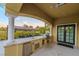 Outdoor kitchen with granite countertops and built-in appliances at 52 Innisbrook Ave, Las Vegas, NV 89113