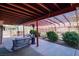 Covered patio with pergola, seating, and lush greenery at 5242 Dickens Dr, Las Vegas, NV 89119