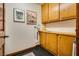 Laundry room with wood cabinets and tile floor at 5242 Dickens Dr, Las Vegas, NV 89119