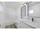 Bathroom boasts double vanity with quartz countertop and black matte fixtures at 5264 Lookout St, Las Vegas, NV 89120