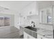 Modern kitchen features white shaker cabinets, a farmhouse sink, and quartz countertops at 5264 Lookout St, Las Vegas, NV 89120