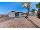 Backyard view of home with gravel and mature tree at 6252 Fairwood Ave, Las Vegas, NV 89107