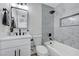 Elegant bathroom with marble tile, a soaking tub, and modern vanity at 6252 Fairwood Ave, Las Vegas, NV 89107