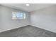 Well-lit bedroom featuring grey carpet and a window with a view at 6252 Fairwood Ave, Las Vegas, NV 89107