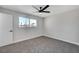 Bright bedroom with a window, ceiling fan and grey carpet at 6252 Fairwood Ave, Las Vegas, NV 89107