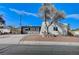 Contemporary home with a red front door and desert landscaping at 6252 Fairwood Ave, Las Vegas, NV 89107