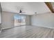 Living area with sliding glass doors, hardwood floors, and ceiling fan at 6252 Fairwood Ave, Las Vegas, NV 89107