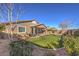 View of home from backyard, artificial turf and landscaping at 6288 Starflare St, Las Vegas, NV 89148