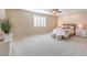 Spacious bedroom with carpeted floor, large window, and ceiling fan at 6288 Starflare St, Las Vegas, NV 89148