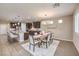 Open dining room with a rustic wood table and chandelier at 6288 Starflare St, Las Vegas, NV 89148