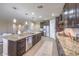 Spacious kitchen with granite countertops and dark wood cabinets at 6288 Starflare St, Las Vegas, NV 89148