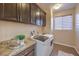 Laundry room with granite countertops and modern washer/dryer at 6288 Starflare St, Las Vegas, NV 89148