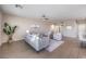 Bright living room with gray sofa and access to backyard at 6288 Starflare St, Las Vegas, NV 89148