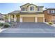 Two-story house with a landscaped yard and two-car garage at 633 Finch Island Ave, Henderson, NV 89015