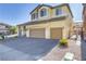 Two-story house with a landscaped yard and two-car garage at 633 Finch Island Ave, Henderson, NV 89015