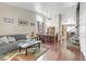 Bright living room with hardwood floors, gray sofa, and a view of the dining area at 633 Finch Island Ave, Henderson, NV 89015