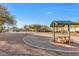 Sandy playground area with picnic tables and shaded seating at 6637 Lookout Lodge Ln # 2, North Las Vegas, NV 89084