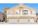 Tan three-story house with a three-car garage at 6637 Lookout Lodge Ln # 2, North Las Vegas, NV 89084