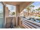 Apartment balcony overlooking parking lot and pool area with palm trees at 6861 Tamarus St # 203, Las Vegas, NV 89119