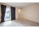 Bright bedroom with sliding glass door to balcony and laminate floors at 6861 Tamarus St # 203, Las Vegas, NV 89119