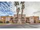 Tan two-story building with palm trees and red curb at 6861 Tamarus St # 203, Las Vegas, NV 89119