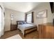 Guest bedroom with a rustic wood bed frame and window with blinds at 7336 Young Doe Ave, Las Vegas, NV 89130