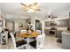 Open-concept kitchen and dining area with gray cabinets and hardwood floors at 7336 Young Doe Ave, Las Vegas, NV 89130