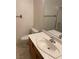 Bathroom with single sink vanity and shower/tub combo at 7509 W Gilmore Ave, Las Vegas, NV 89129