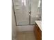 Bathroom with shower/tub combo and tiled walls at 7509 W Gilmore Ave, Las Vegas, NV 89129