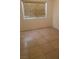 Bright bedroom with tile flooring and large window at 7509 W Gilmore Ave, Las Vegas, NV 89129