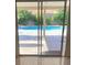 Glass sliding doors open to a view of the refreshing pool at 7509 W Gilmore Ave, Las Vegas, NV 89129