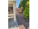 Landscaped side yard with gravel and rock features at 7509 W Gilmore Ave, Las Vegas, NV 89129