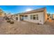 Backyard with covered patio and gravel at 7824 Homing Pigeon St, North Las Vegas, NV 89084