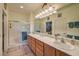 Double vanity bathroom with a large mirror and walk-in shower at 7824 Homing Pigeon St, North Las Vegas, NV 89084