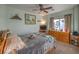 Bright bedroom featuring a dresser and ceiling fan at 7824 Homing Pigeon St, North Las Vegas, NV 89084