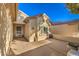 Front entrance with a gated entry and a stone planter at 7824 Homing Pigeon St, North Las Vegas, NV 89084