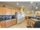 Kitchen with granite countertops, wooden cabinets, and stainless steel appliances at 7824 Homing Pigeon St, North Las Vegas, NV 89084