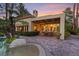 Outdoor living space with a patio, spa, and palm trees, ideal for entertaining and enjoying the serene backyard at 8199 Pinnacle Peak Ave, Las Vegas, NV 89113