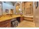 Elegant bathroom with stone wall, large vanity, and soaking tub at 8199 Pinnacle Peak Ave, Las Vegas, NV 89113