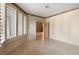 Bright bedroom featuring big windows with shutters and neutral walls at 8199 Pinnacle Peak Ave, Las Vegas, NV 89113