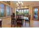 Bright dining room featuring hardwood floors, large windows and a wood table at 8199 Pinnacle Peak Ave, Las Vegas, NV 89113