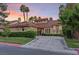 Attractive single-story home showcasing lush green landscaping, a red-tiled roof, and a circular window feature at 8199 Pinnacle Peak Ave, Las Vegas, NV 89113