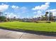 Beautiful view of the well-manicured golf course with lush green grass and palm trees under a bright sky at 8199 Pinnacle Peak Ave, Las Vegas, NV 89113